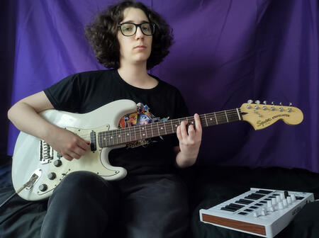 Photo of me with a guitar and keyboard